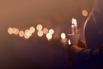 The nurse is showing the power of candlelight to commemorate those who have valued the past.