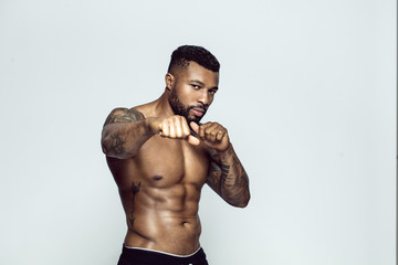 Portrait of tattooed athlete boxing