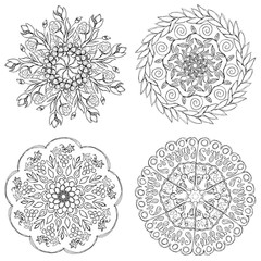 A set of black and white mandalas. Decorative round ornaments. Wicker design elements. Logos for yoga, backgrounds for posters, icons for programs and websites. The unusual shape of the flower. 