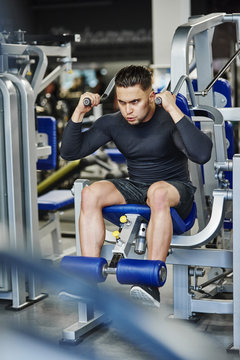 Man training with exercise machine in the gym