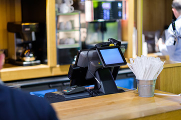 Cash desk terminal with screen in small cafe