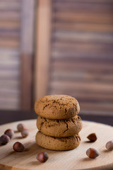 oatmeal cookies with hazelnuts wooden background