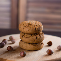 oatmeal cookies with hazelnuts wooden background