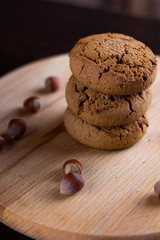 oatmeal cookies with hazelnuts wooden background