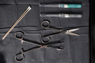 Body piercing equipment in a tattoo shop on a sterile mat