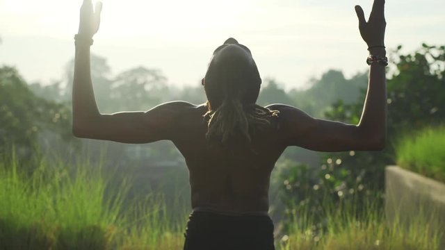 Black afro man do bikram yoga at roof top with solar battery rapid slow motion