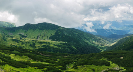 Beautiful view of the green hills and clouds in the Carpathian Mountains