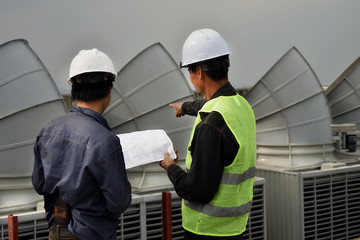 Team of engineer people in group on construction site check drawing and business workflow