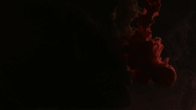 red and white ink in water with Skull on black background