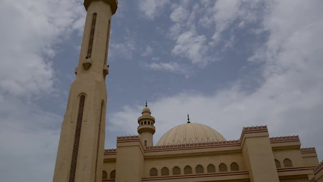 Top down pan of the Grand Mosque in Manama, Bahrain with two women wearing black abaya dresses and hajibs