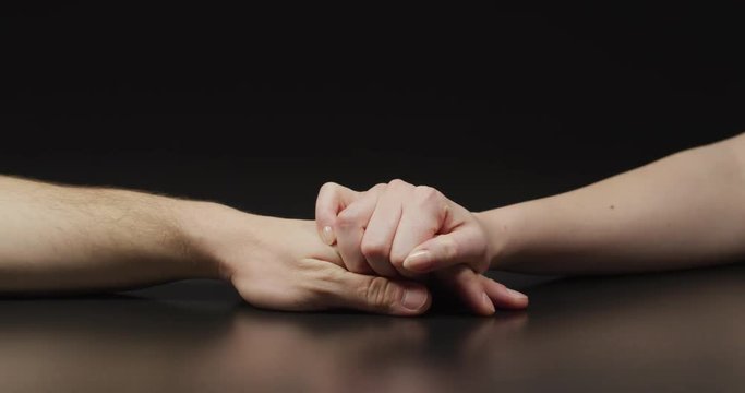 Woman holding man's hand