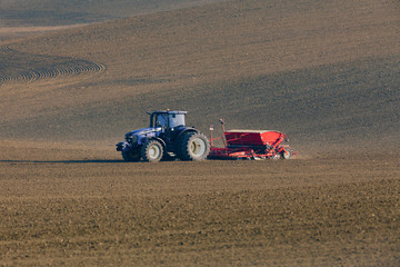 Fototapeta premium tractor with seed drill on field