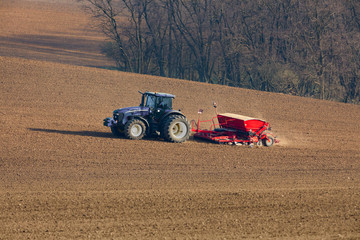 Fototapeta premium tractor with seed drill on field