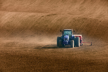 tractor with seed drill on field