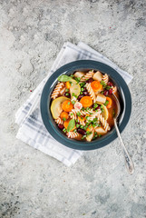 Italian vegetable soup Minestrone with fusilli pasta,  vegetarian food concept, grey stone background, copy space