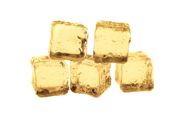 Golden ice cubes on white background.
