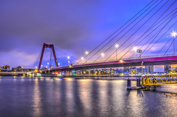 Fototapeta na wymiar Early morning view of Willemsbridge across the river Nieuwe Maas in Rotterdam, The Netherlands