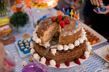 detail of strawberry and meringue naked cake, seen from above, 3 stories high