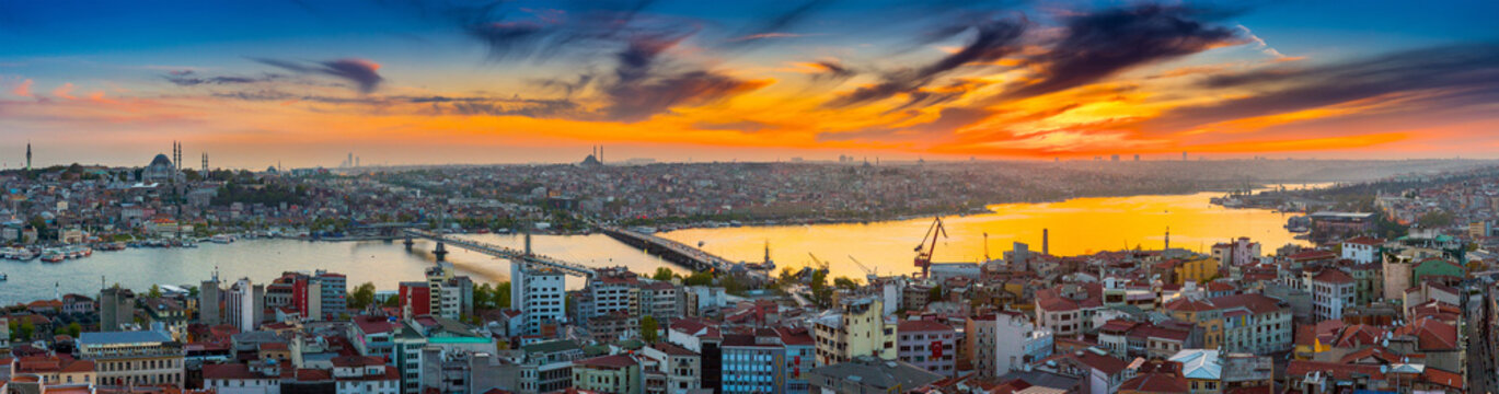 Long exposure panoramic cityscape of Istanbul at a beautiful dramatic clouds sunset from Galata to Golden Horn gulf. View of the wonderful romantic old town at Sea of Marmara. Istanbul. Turkey.