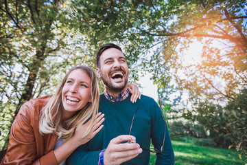 Happy couple in love having fun outdoors and smiling.