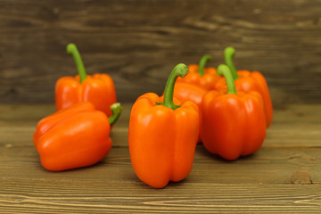Colorful pepper isolated on wooden table
