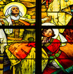 Fototapeta premium Detail of art nouveau stained glass window by Alfons Mucha, St. Vitus Cathedral, Prague castle, Czech Republic - Czech patron saint St. Wenceslas (as boy) with his grandmother St. Ludmila 