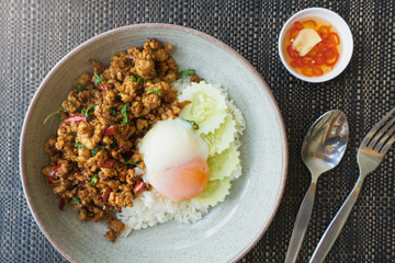 Rice topped with stir fried minced pork and basil. Thaifood concept.  Pad Ka Phrao, fried meat with chili, garlic and holy basil. eat with rice and fried egg. Thai famous food.