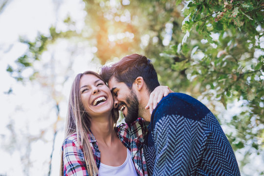 Happy couple in love having fun outdoors and smiling.