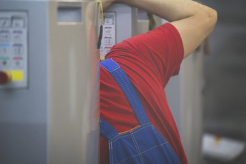 Shoulder of the worker man behind the printing press