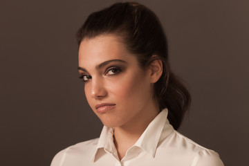 Beautiful woman portrait wearing white blouse and looking at camera