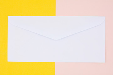 white envelope mail on yellow and pink background