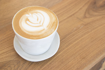 Coffee cup with Latte art foam,Hot coffee in traditional style coffee shop ready for breakfast.