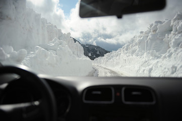 Car view on road in the mountains among the snow