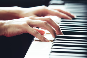 Close up of woman hands playing and practicing piano