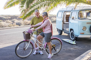 alternative lifestyle with vintage van and bike for senior adult couple always live forever...
