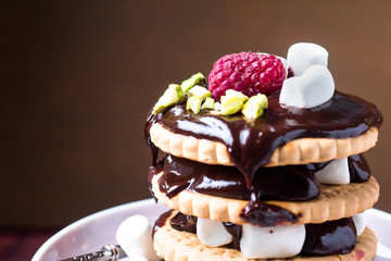 A sweet dessert of chocolate biscuit, raspberry marshmallow and