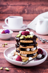 A sweet dessert of chocolate biscuit, raspberry marshmallow and