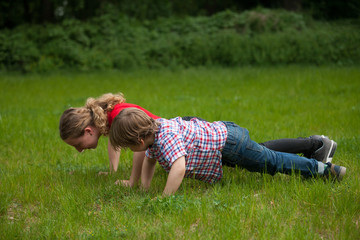 Girl and little boy doing push-ups
