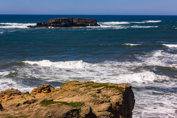 white waves coming into rock shore