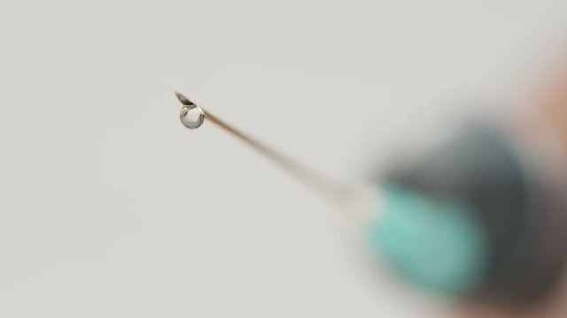 Droplets falling from a syringe needle