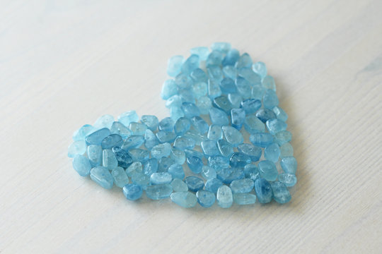 Aquamarine is blue. Blue heart. Natural stone is blue aquamarine. The background is aquamarine. Place for text. Card