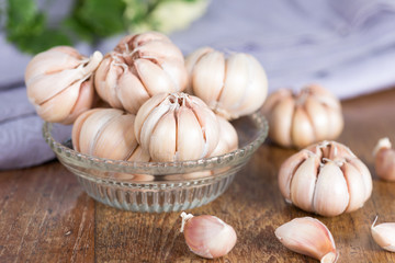 Garlic cloves and Garlic bulb on glass bowl.