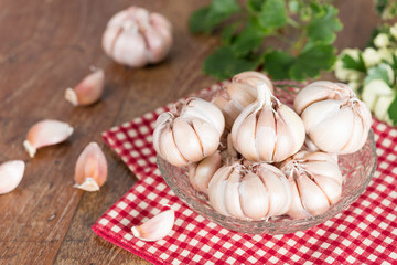 Garlic cloves and Garlic bulb on glass bowl.