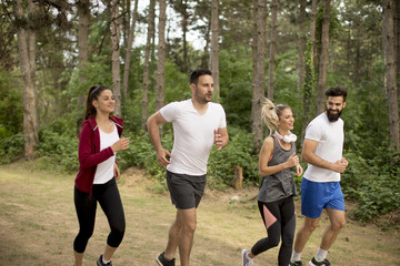 Young people run a marathon through the forest