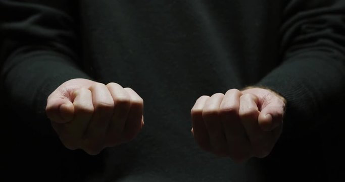 Hand opening to reveal two pills