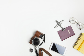 Travel objects flat lay on white background with copy space