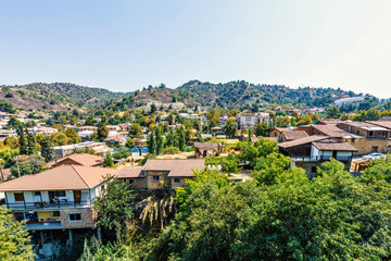 Fototapeta na wymiar Daylight view from above to city buildings and Troodos Mountains