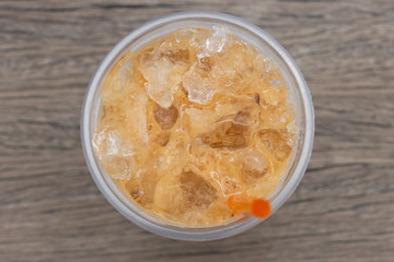 Coffee cool moment the sun is low. On a wooden chair in the park