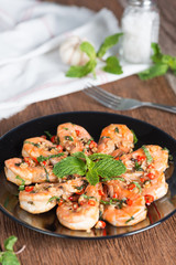 Stir-fried Shrimp with pepper and garlic on black plate.