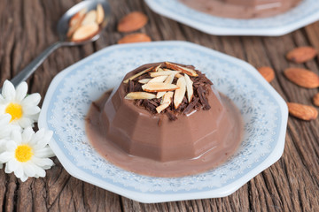 Chocolate pudding topping of chocolate and almond sliced.
